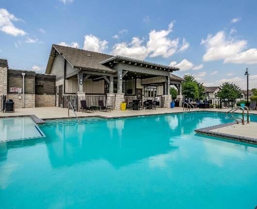 Apartment complex pool with gate around it.